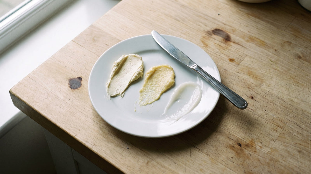 Three creams smeared side by side on a white plate showing how differently they behave